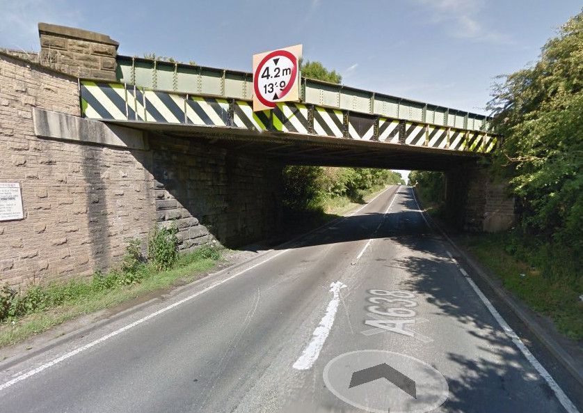 Road closed after lorry and car crash under railway bridge